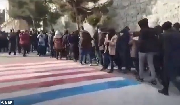Iranian students refuse to step on the American and Israeli flags in a video taken Sunday