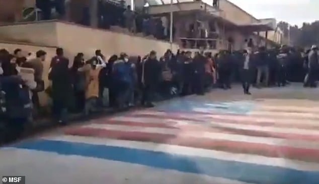 The clip taken at Shaheed Beheshti University on Sunday shows crowds deliberately avoiding walking over the Stars and Stripes and the Star of David