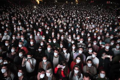 FILE - People using face masks attend a music concert in Barcelona, Spain, March 27, 2021. With one of Europe's highest vaccination rates and its most pandemic-battered economies, the Spanish government is laying the groundwork to approach the virus in much the same way countries deal with flu or measles. (AP Photo/Emilio Morenatti, File) FILE - People using face masks attend a music concert in Barcelona, Spain, March 27, 2021. With one of Europe's highest vaccination rates and its most pandemic-battered economies, the Spanish government is laying the groundwork to approach the virus in much the same way countries deal with flu or measles. (AP Photo/Emilio Morenatti, File)