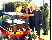 story.casket.mourners.jpg