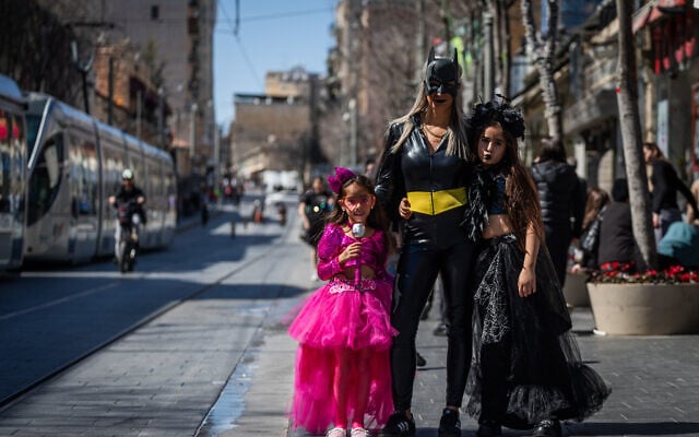 Israelis dressed in costumes walk on Jaffa Street in Jerusalem on March 12, 2025, ahead of the Jewish holiday of Purim. (Yonatan Sindel/Flash90)