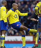 Thierry Henry scores in a 2-0 win over Aston Villa last January 