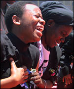 [ image: One of Dr Nyerere's daughter's views her father's coffin]