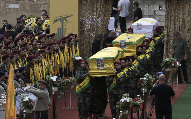 Hezbollah members carry the coffin of four fallen comrades who were killed Monday after their handheld pagers exploded, in the southern suburb of Beirut, Lebanon, Wednesday, Sept. 18, 2024. The attack was blamed on Israel (AP Photo/Bilal Hussein) Hezbollah members carry the coffin of four fallen comrades who were killed Monday after their handheld pagers exploded, in the southern suburb of Beirut, Lebanon, Wednesday, Sept. 18, 2024. The attack was blamed on Israel (AP Photo/Bilal Hussein)