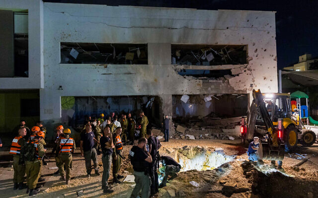Israeli security forces at the scene where a missile fired from Iran hit a school in the town of Gedera, October 1, 2024. (Liron Moldovan/Flash90) Israeli security forces at the scene where a missile fired from Iran hit a school in the town of Gedera, October 1, 2024. (Liron Moldovan/Flash90)