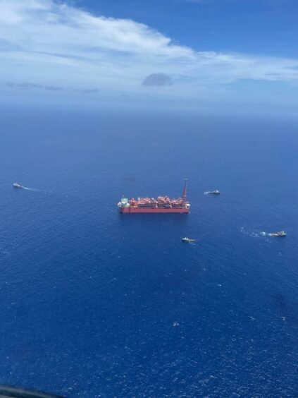 A red vessel in a big blue sea A red vessel in a big blue sea
